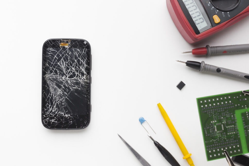 top-view-broken-phone-with-electronic-tools